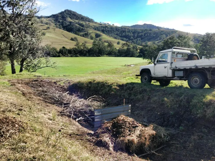 The first compost bays dug into the hillside on the farm, with the ute parked above